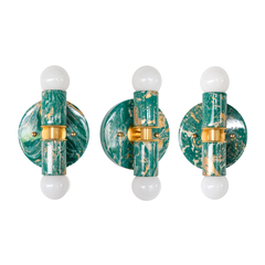 Three small Thalia sconces in mermaid green, cream, and gold marbled finish with round backplates, brass center bands, and two white globe bulbs each, shown side by side as one-of-a-kind variations. Compact high impact wall sconce or flush mount ceiling light for a feminine bathroom, pretty powder room, pastel interior design, coastal modern, or eclectic home.
