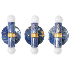 Three handmade blue marbled Thalia sconces are shown side by side to highlight the variation in each hand-marbled finish. Swirls of cobalt, navy, lighter blue, and touches of gold create a one-of-a-kind look that feels artistic, eclectic, and slightly coastal. These blue wall sconces are ideal for customers looking for a colorful statement light with a handcrafted finish.