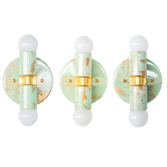 A set of mint, cream, and gold Small Thalia Sconces with hand-marbled patterns, each one slightly different because of the handmade finish. The small two-light wall fixture brings personality without feeling too loud, making it ideal for muted colorful bathrooms, powder rooms, kids bath designs, and eclectic vanity lighting. The soft green and ivory marbling gives the sconce a fresh, small-batch feel that fits chinoiserie, grandmillennial, cottage, and playful traditional spaces.