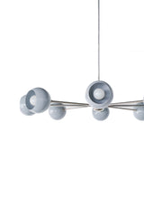 Closeup view of the Arcenciel sputnik chandelier showing slate grey globe shades with exposed white bulbs and polished chrome arms, a modern designer ceiling fixture with a clean architectural profile, ideal for Scandinavian interiors, modern lofts, and mid century inspired rooms as a statement dining room chandelier or contemporary kitchen lighting.