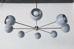Modern Arcenciel globe chandelier in slate grey with chrome sputnik arms and a central stem mount, featuring rounded metal shades with visible bulbs for a crisp modern look, a statement ceiling light for contemporary dining rooms, modern living rooms, kitchen islands, and design-forward minimalist interiors.
