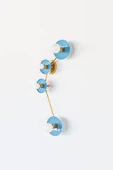 Aries zodiac wall sconce in Hydrangea Blue with warm brass hardware, constellation inspired modern wall light with four glossy powder coated steel disc shades and opal globe bulbs, sculptural statement sconce for a bathroom vanity over a mirror, powder room, entryway, bedside lighting, or colorful maximalist home decor, mid century modern brass and blue wall lighting that adds a bright saturated pop of color with a chic celestial vibe.