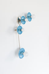 Aries zodiac wall sconce in Hydrangea Blue with polished chrome hardware, a modern constellation style light fixture with four round powder coated steel discs and opal globe bulbs on a slim curved arm, bold blue accent lighting for a contemporary bathroom vanity, hallway, bedroom, kids room, or maximalist interior design, playful modern wall lighting with a clean glossy pop of color and sculptural mid century inspired silhouette.