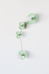 Aries zodiac wall sconce in Mint with polished chrome hardware, a modern constellation style light fixture with four round powder coated steel discs and opal globe bulbs on a slim curved arm, bold blue accent lighting for a contemporary bathroom vanity, hallway, bedroom, kids room, or maximalist interior design, playful modern wall lighting with a clean glossy pop of color and sculptural mid century inspired silhouette.