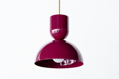 Black cherry is the color that makes a room feel rich and a little sultry, and this Taeuber pendant delivers it in a punchy, sculptural shape. The two-part silhouette stacks a rounded cup over a wide domed bell, all finished in a deep glossy black cherry with a warm brass stem. It reads jewel-toned and confident, the kind of statement lighting that turns a kitchen island, breakfast nook, or bar into a focal point. Hang one for a hit of saturated color or a row for real drama. A great choice for a colorful, 