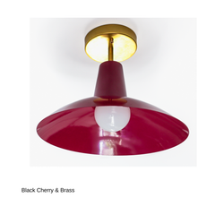 A black cherry flushmount with a cone-shaped neck opening into a shallow saucer shade, paired with warm brass hardware. The exposed bulb sits just below the shade's edge. A confident, saturated alternative to a standard neutral flush mount, good for a hallway, entry, or any room that wants one strong colorful moment overhead.