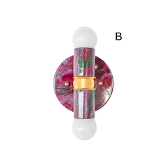 A side view of a two-light marbled wall sconce in black cherry, lilac, and green, showing how far the fixture sits off the wall. Brass hardware connects the upper and lower arms, each with an exposed globe bulb. Good reference for anyone weighing scale and projection before choosing a statement sconce for a small bathroom or hallway.
