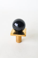 Glossy black square gumball knob with solid brass base—bold, modern cabinet hardware for kitchens, bathrooms, dressers, or built-ins. Sleek black finish adds contrast, depth, and elevated style to furniture and interiors. Great for minimalist, luxe, or eclectic home decor upgrades.