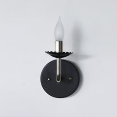 Black and chrome feminine wall sconce with scalloped bobeche detail