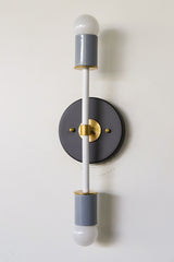 Neutral colorblocked Thalia two-light sconce in black, white, and gray with brass accents, modern bathroom sconce for powder room, hallway, or minimal mid-century vibe