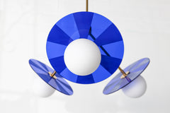 Bright blue and brass etched acrylic chandelier with mid century modern vibes for boy's room or kids playroom