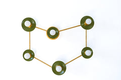 A Capricorn constellation wall sconce with six globe bulbs set in glossy olive green disc shades, each one a star, linked by thin raw brass rods that trace the sea goat sign. Olive and brass feel grounded and earthy, a good match for an earth sign. Hang it over a bed, a sofa, or a home office desk. It suits celestial bedroom decor, earthy modern rooms, and zodiac wall art ideas, and makes a thoughtful birthday or holiday gift for the Capricorn in your life.
