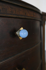 Celestial blue and brass square gumball drawer pulls installed on a vintage wood dresser. These pastel blue knobs add a charming pop of color and whimsy to bedroom furniture, bathroom cabinets, or nursery drawers. Handmade, colorful hardware for modern or eclectic interiors.