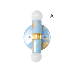 Close-up product photo of the Celestial, Cream, and Gold hand-marbled Small Thalia Sconce with white globe bulbs, brass hardware, and a glossy marbled blue finish. The compact vertical shape makes it a charming wall light for small bathrooms, powder rooms, kids baths, cottage style homes, pastel interiors, and chinoiserie-inspired spaces.