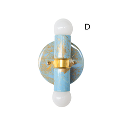 Product detail of the Small Thalia Sconce in a Celestial blue, cream, and gold hand-marbled finish with brass hardware and white globe bulbs. The muted blue colorway feels fresh, sweet, and easy to style, especially in bathrooms with wallpaper, white tile, pastel palettes, coastal cottage decor, kids spaces, and grandmillennial or chinoiserie-inspired rooms.