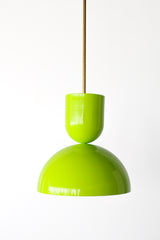There's something exciting about a fixture that commits to a color this bold, and this Taeuber pendant does it in a crisp sculptural silhouette. Unlit, the shape really reads: a rounded cup top stacked over a wide domed bell, finished in glossy chartreuse and hung from a warm brass stem. It's a versatile scale for a kitchen island, a bar, a breakfast nook, or a playful entry, bringing saturated, high-energy color wherever it lands. Cluster a few or let one stand alone as a fearless pop. Ideal for a home tha