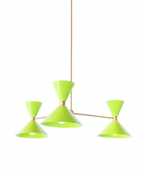 Bright chartreuse and warm brass is the pairing that makes a room feel fearless, fresh, and full of energy, and this mid-century modern Clancy chandelier brings them together beautifully. Three glossy yellow-green double-cone shades radiate from a brass central hub on slim brass arms, in a fun, sculptural MCM silhouette that throws light up and down from each arm. The brass stem and collars warm up the electric green and give the whole piece a polished, collected feel. It's built to be the star over a dinin