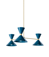 A deep lagoon-blue chandelier with a moodier register, perfect for a dining room, study, or bedroom that wants color with some restraint. The Clancy Chandelier pairs three splayed brass arms with glossy teal hourglass double-cone shades, each hung at a slightly different height for a relaxed, asymmetric silhouette. This dusky blue-green leans coastal traditional one moment and library-serious the next, gorgeous against dark walls, warm wood, or collected antiques. A grown-up color statement for moody, mid-c