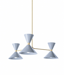 Soft grey and warm brass is the pairing that feels calm, cool, and quietly polished, and this mid-century modern Clancy chandelier makes it sing. Three glossy slate grey double-cone shades radiate from a brass central hub on slim brass arms, in a fun, sculptural MCM silhouette that throws light up and down from each arm. The warm brass stem and collars keep the cool grey from feeling flat and give the whole piece a collected, considered edge. It's built to be the star over a dining table, kitchen island, or