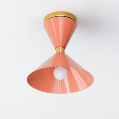 Peach and Brass flushmount ceiling light fixture in a midcentury modern double cone shape