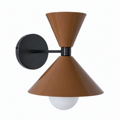A warm caramel-brown wall sconce with black hardware that brings rich, retro color to a powder room, hallway, or bedside. The Clancy Sconce carries the same sculptural double-cone shade as the Clancy chandelier, a wide cone below and a smaller cone flaring up above, here in glossy fudge brown with a matching black collar, arm, and round backplate. This toffee tone reads earthy and a little 70s, cozy against cream walls, natural wood, terracotta tile, or a moody paint color. A rich, grounding pick for mid-ce