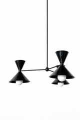 An all-black chandelier stripped down to pure silhouette, made for a dining room, entryway, or study that wants a sleek, graphic focal point with no competing shine. Each of the three arms ends in a double-cone shade, a broad cone below that throws light down and a smaller cone flaring up above, joined at a black collar, with the stem, arms, and central hub all finished to match. The arms hang at staggered heights for a loose, sculptural look, and the drop can be sized to your ceiling. Head-to-toe black rea