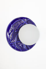 Front view of cobalt blue Leafy ceramic wall sconce with frosted glass globe, sculptural leaf-textured backplate, modern globe sconce for bathroom, hallway, or bedside.