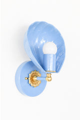 Pastel soft blue lighting sconce in the shape of a shell with cast brass details. Slightly nautical and slightly chinoiserie, this is a delicate looking sconce with beautiful details. It can be used in a bathroom, in a commercial setting, or as an accent piece to provide ambient lighting. We light the coastal vibes.