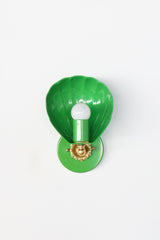 Seen head-on, the Coquille Sconce in Spring Green shows its full scallop silhouette, with fluting radiating around an exposed globe bulb. The glossy kelly green powder coat covers the shell, socket, and round backplate, while a cast brass rosette and ball detail add vintage-inspired polish. A cheerful, confident choice for green bathrooms, kids bathrooms, garden-inspired powder rooms, and colorful traditional homes.