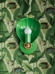 Green on green, and a shell right at home in the aquarium. Naturalist fish weave through tall leaves on this green wallpaper, and the Coquille Sconce in Spring Green joins the underwater scene like it was drawn into the print. The glossy scallop shade and cast brass rosette add dimension without breaking the tonal palette. For maximalist powder rooms, fish wallpaper bathrooms, and anyone who thinks matching your sconce to your wallpaper is a feature, not a risk.