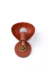 Close-up studio photo of the Terra Cotta Coquille Sconce highlighting its sculptural shell silhouette, rich terra cotta finish, and ornate brass rosette detail. The clean background keeps the focus on the fixture’s curving form and decorative character, making it easy to see the craftsmanship and distinctive shape. This unique wall light is ideal for coastal decor, Mediterranean-inspired interiors, feminine bedrooms, powder rooms, and statement sconce lighting with a warm, playful feel.