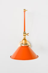 Bright Orange and Brass adjustable cone sconce for kitchen lighting above windows or above open shelving cabinetry.  Also makes a great bedside reading light that frees up space on your nightstands. Comes in three finishes and over 30 colors for a custom look.  Available in neutrals or fun, bright colors that work in any maximalist or kid-friendly space.  Classic style wall sconce that has been updated by our curated color palette of brights, darks, and pastel hues.  Designed and made by Sazerac Stitches.
