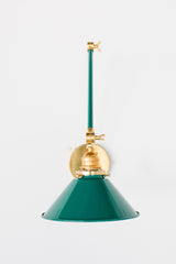 Mermaid Green and Brass adjustable cone sconce for kitchen lighting above windows or above open shelving cabinetry.  Also makes a great bedside reading light that frees up space on your nightstands. Comes in three finishes and over 30 colors for a custom look.  Available in neutrals or fun, bright colors that work in any maximalist or kid-friendly space.  Classic style wall sconce that has been updated by our curated color palette of brights, darks, and pastel hues.  Designed and made by Sazerac Stitches.