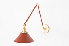 Terra Cotta and Brass adjustable cone sconce for kitchen lighting above windows or above open shelving cabinetry.  Also makes a great bedside reading light that frees up space on your nightstands. Comes in three finishes and over 30 colors for a custom look.  Available in neutrals or fun, bright colors that work in any maximalist or kid-friendly space.  Classic style wall sconce that has been updated by our curated color palette of brights, darks, and pastel hues.  Designed and made by Sazerac Stitches.