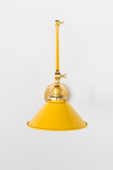 Yellow and Brass adjustable cone sconce for kitchen lighting above windows or above open shelving cabinetry.  Also makes a great bedside reading light that frees up space on your nightstands. Comes in three finishes and over 30 colors for a custom look.  Available in neutrals or fun, bright colors that work in any maximalist or kid-friendly space.  Classic style wall sconce that has been updated by our curated color palette of brights, darks, and pastel hues.  Designed and made by Sazerac Stitches.