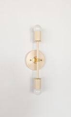 Cream-on-cream color-drenched modern wall sconce with brass accents, double globe bulb vertical fixture with round backplate, mid century modern lighting for bathroom vanity, hallway, or bedroom, minimalist monochrome decor wall light by Sazerac Stitches