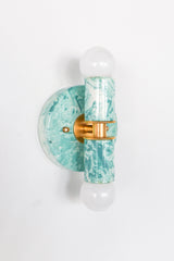 Close-up of teal and cream marbled Thalia sconce, sculptural two-light wall fixture with swirling, sea-glass tones, perfect as a designer bathroom sconce, hallway statement light, or bedside wall lighting