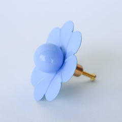 Bring a calming, coastal feel to your furniture with the Celestial Blue Daisy Knob by Sazerac Stitches. This elegant drawer pull in a rich lagoon blue features smooth petals and a glossy center, adding a touch of sophistication and a splash of color to any space. Perfect for giving cabinets and drawers a serene, vintage-inspired accent.