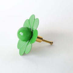 Add a fresh, fun twist to your furniture with the Spring Green Floral Knob by Sazerac Stitches. This eye-catching drawer pull, designed with petal-shaped details and a glossy center, brings a lively retro vibe to any room. Ideal for brightening up a nursery or adding a unique accent to your home decor.