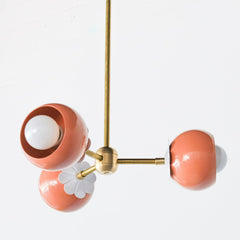 Peach and Brass chandelier with white daisy flower detail.  Feminine 60s style small chandelier adds a pop of color and whimsy to any small space like bedroom, playroom, office, or bathroom design