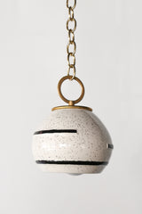 Neutral cream and black speckled geometric pendant lamp with oversized brass loop on brass chain.  Boho style modern Pendant light that can be swagged.  Textural pendant that is perfect for neutral spaces.  Adds a handmade quality to a space.  Designed and assembled in New Orleans.  The ceramic shades are made in North Carolina.