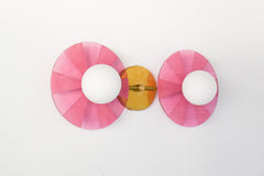 Modern colorful light fixture: The Circus Sconce in pink & Brass