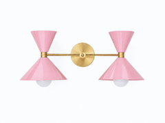 delicate and feminine blush pink and brass two light oversized bathroom wall sconce. Mid-century modern style wall sconce that is perfect for bold, colorful bathrooms, kids bathrooms, eclectic design, and more.  Fun way to introduce color to a bathroom or match wallpaper. Helps create a statement bathroom or powder room.