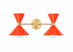 Bold and vibrant poppy-red color named Flame mixed with raw brass accents in this mid-century mdoern style two light bathroom vanity wall sconce with oversized cone shades. Add a pop of color, match a colorful wallpaper, or make a kids bathroom high-end and colorful with the Double Clancy wall sconce by Sazerac Stitches. The glossy orange-red shades are bold, fun, and great to add punch to a bathroom. 