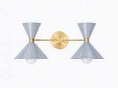 neutral and delicate pastel grey and brass two light large bathroom vanity wall sconce. Made in New orleans by sazerac stitches. Oversized two cone shaped-shades with brass hardware.  Perfectly neutral and calm for a mid-century inspired spa bathroom design.  