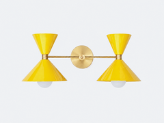 punchy and retro yellow and brass oversized wall sconce with cone shades. mid-century modern style oversized bathroom vanity light fixture.
