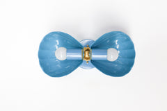 A closer look at the slate blue Double Coquille sconce, showing the fluted shell texture and ornate brass center rosette in more detail. Useful for coastal traditional or Southern feminine bathrooms wanting a softer blue with real shape and shine from their vanity lighting.