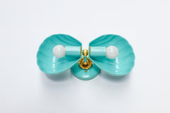 A tight close-up of the poolside turquoise Double Coquille sconce, focused on the scalloped shell texture and brass rosette hardware. Good for anyone comparing finish and detail on a coastal bathroom or grandmillennial powder room sconce.