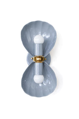 Grey lighting usually means playing it safe, but this slate grey Coquille sconce keeps the fluted shell shape and ornate brass rosette doing the real work. It's a good middle ground for anyone who wants texture and detail without full-on color commitment, think a moody transitional bathroom, a modern traditional entryway, or a bedroom where the walls or bedding already carry the palette and the lighting just needs to hold its own. Reads more architectural than the plain white version, with enough depth to s