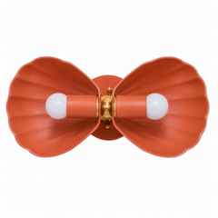 A charming two-shell sconce for a powder room, vanity, or entry that wants a wall light with real personality. The Double Coquille Sconce sends two fluted, scalloped shell shades out to either side of a decorative brass rosette, a symmetrical bowtie shape that feels part coastal, part Hollywood Regency. Here in a warm matte terracotta with a color-matched backplate and glowing brass center, it reads earthy and playful at once, lovely against white plaster, zellige tile, grasscloth, or a moody wall. A charac